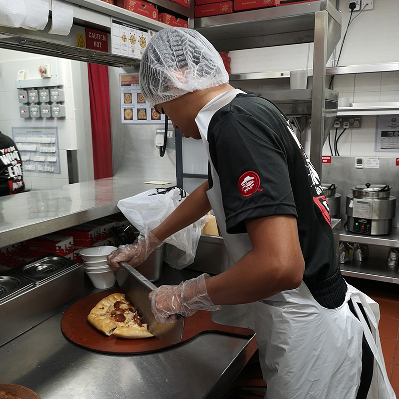 Students learning vocational skills at Pizza Hut